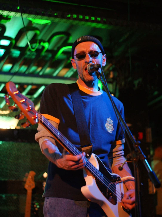 a male musician is performing while looking down