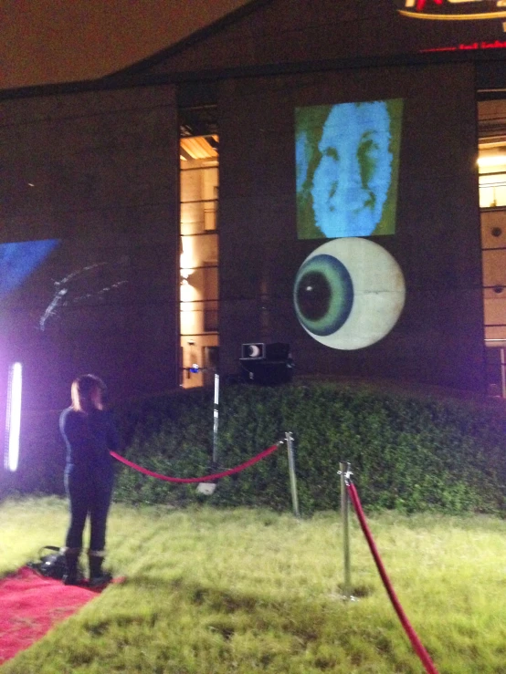 a red carpet with a banner that has some eyes on it