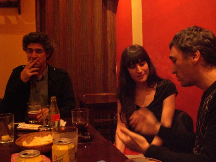 a group of people sitting around a dinner table