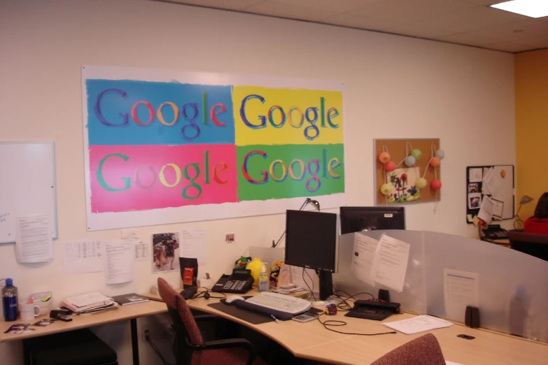 a work cubicle with computers and other office supplies