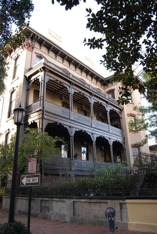 a large building with wrought iron fencing on top