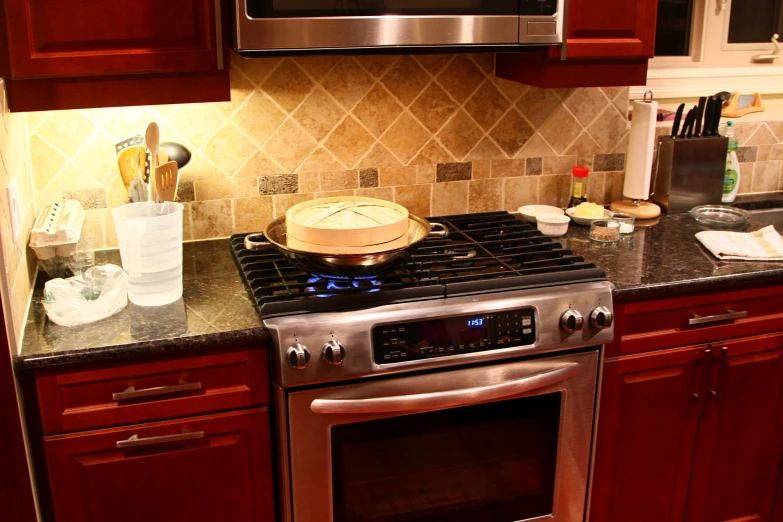 a kitchen area with a stove and silver oven