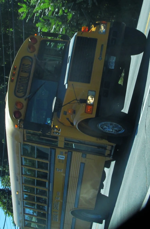 a yellow school bus driving down a street