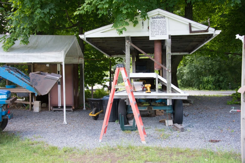 a set of ladders near the back of a truck with the roof on