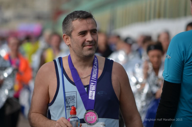 a man is wearing a medals around his neck