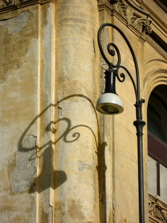 a street light sitting next to an old building