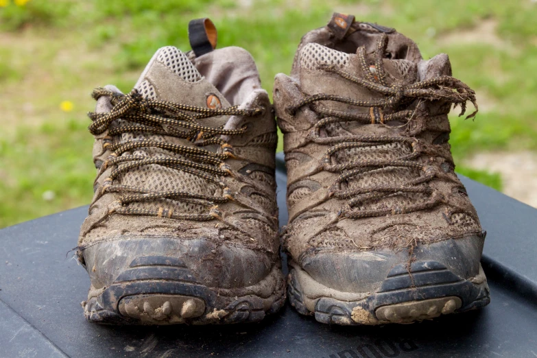 pair of hiking shoes showing dirty leather toe