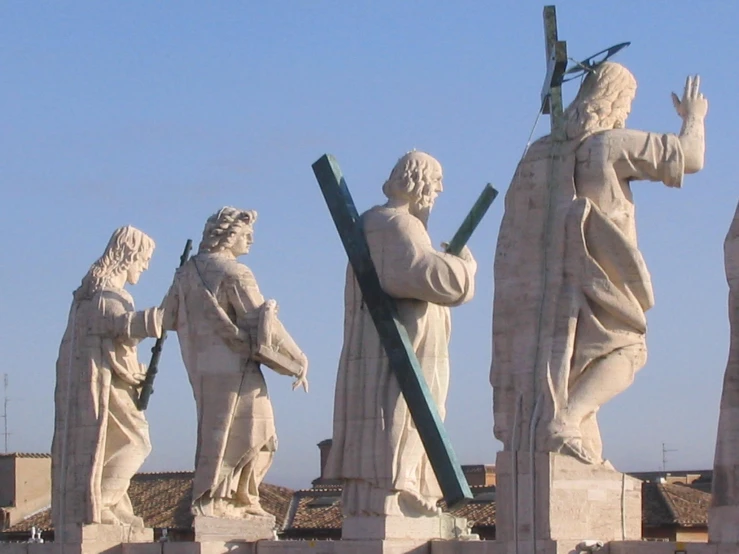 a group of statues on the roof of a building