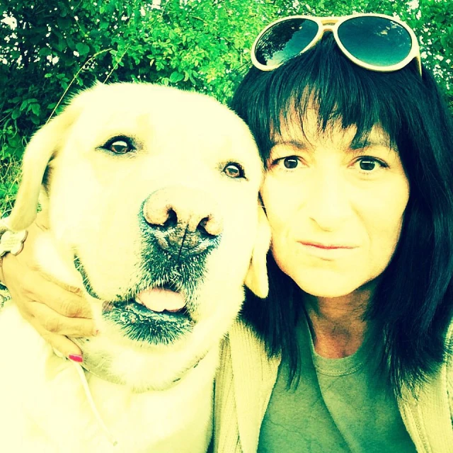 a woman and dog posing for a po