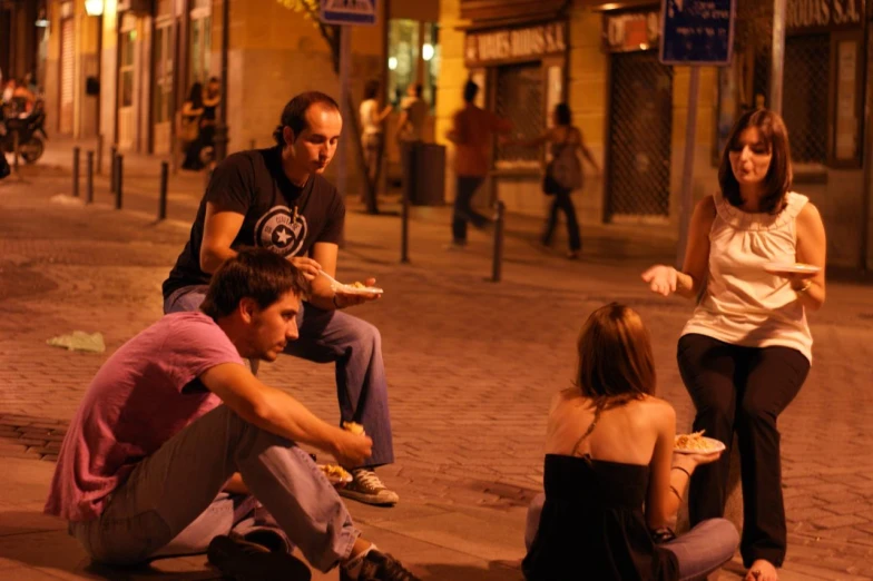 three people are gathered around on the street