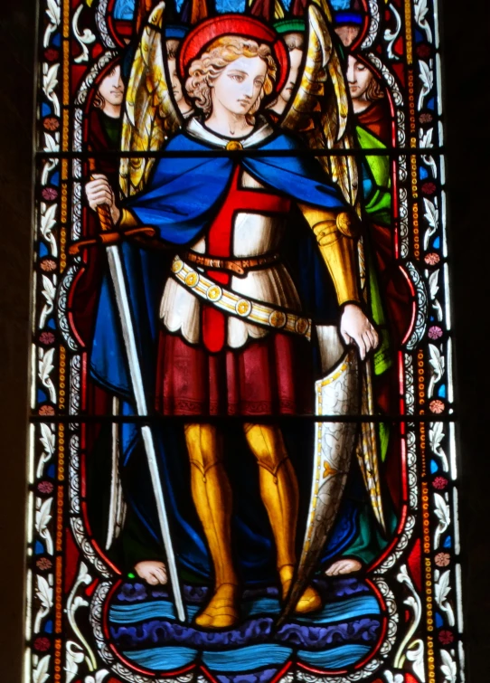 a stain glass depicting an angel and a saint in a cathedral