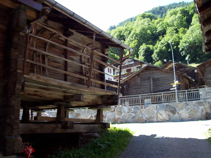 wooden buildings with stone walls near trees