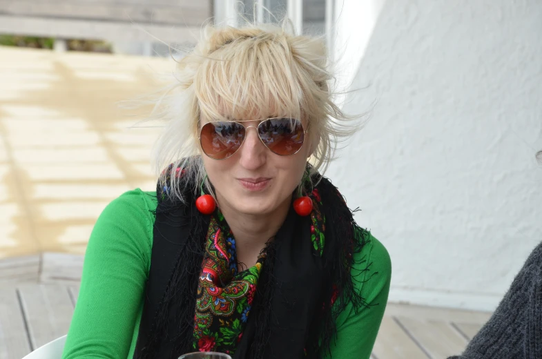 an image of woman with sunglasses on her head with beverage