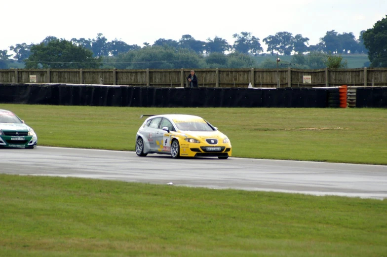 two cars on the track on a cloudy day