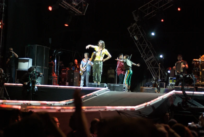 people on a stage, some with microphones