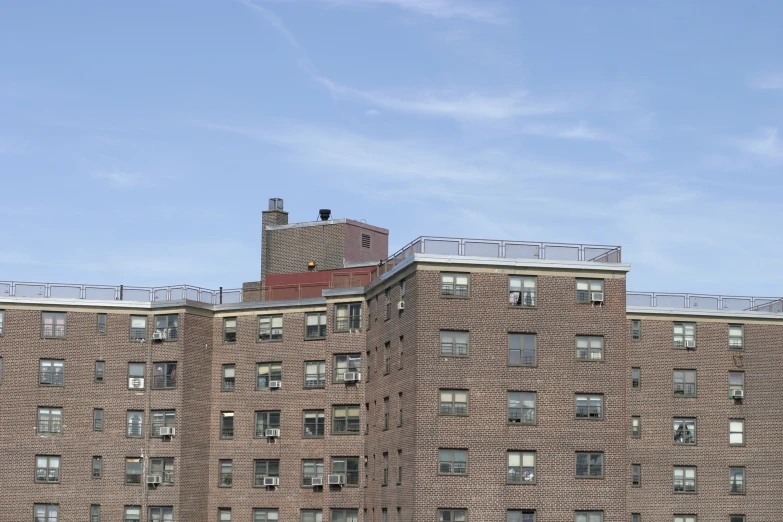 a large brick building with some balconies on the roof