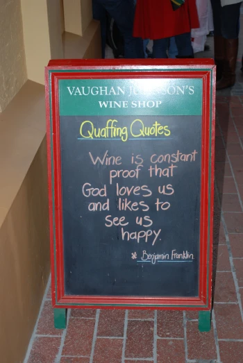 a small menu sign that says quanching quotes wine is important, proof that god loves us and likes to see us happy