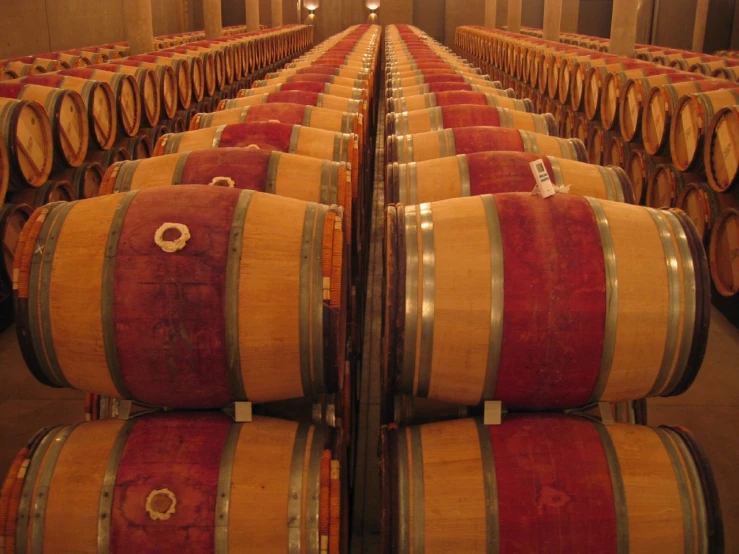 a row of wine barrels stacked up next to each other