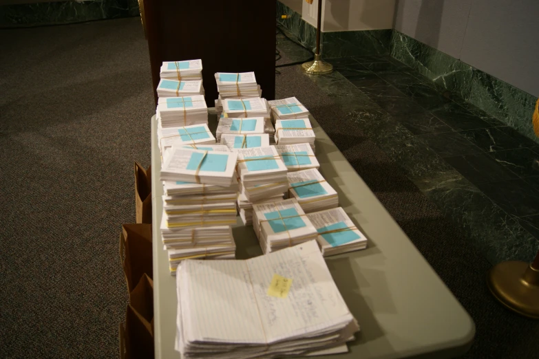 a table filled with books and notes in front of a microphone