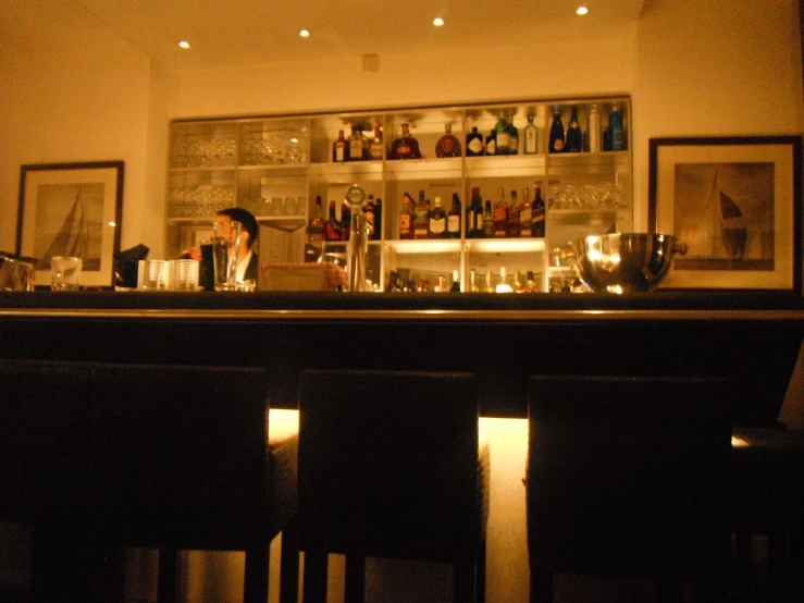 a bar with two people at it and candles on the side