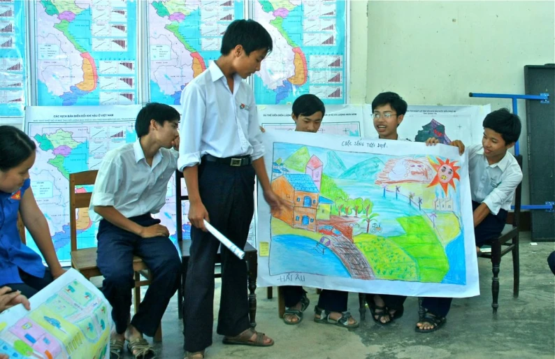 a group of children looking at a large map