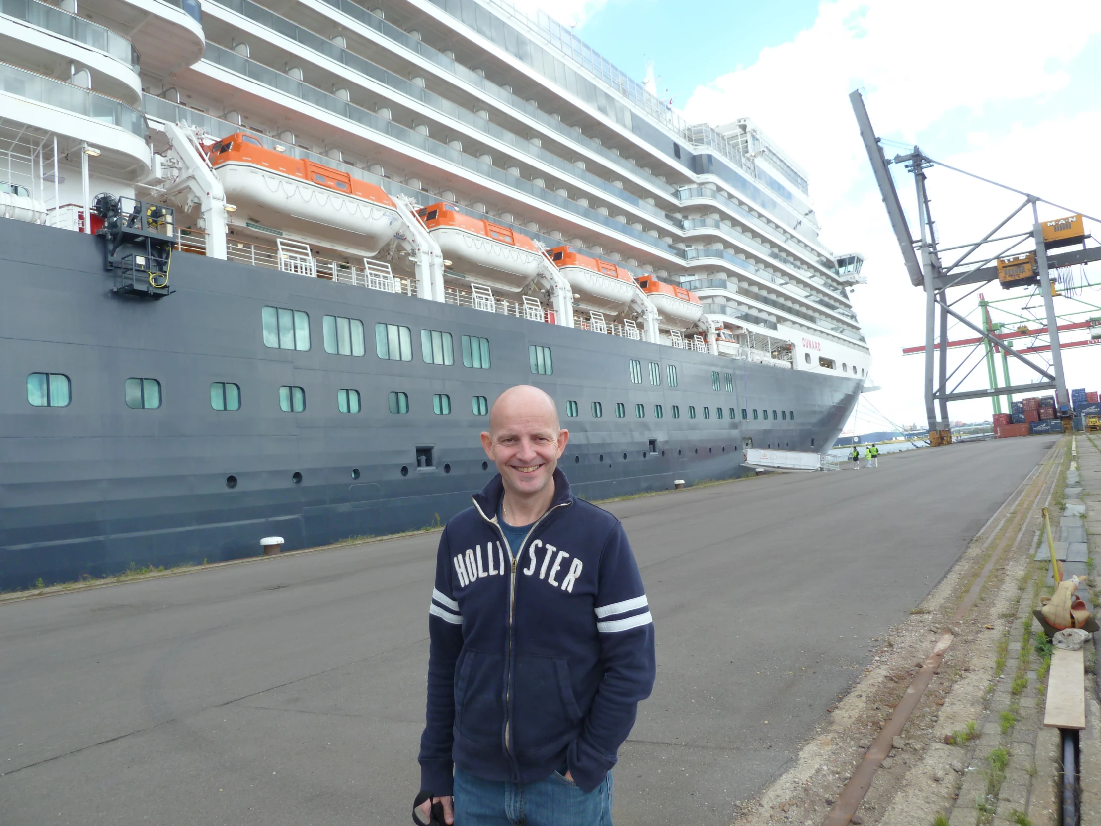 a man standing in front of a cruise ship