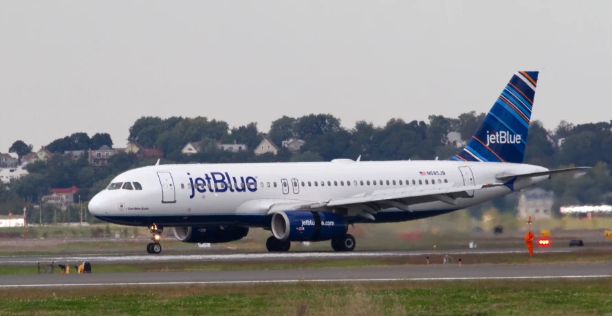 a jetblue airplane sitting on the runway