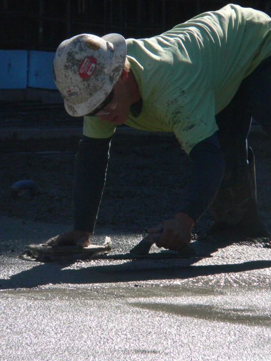 a man bending over in the street with his hands