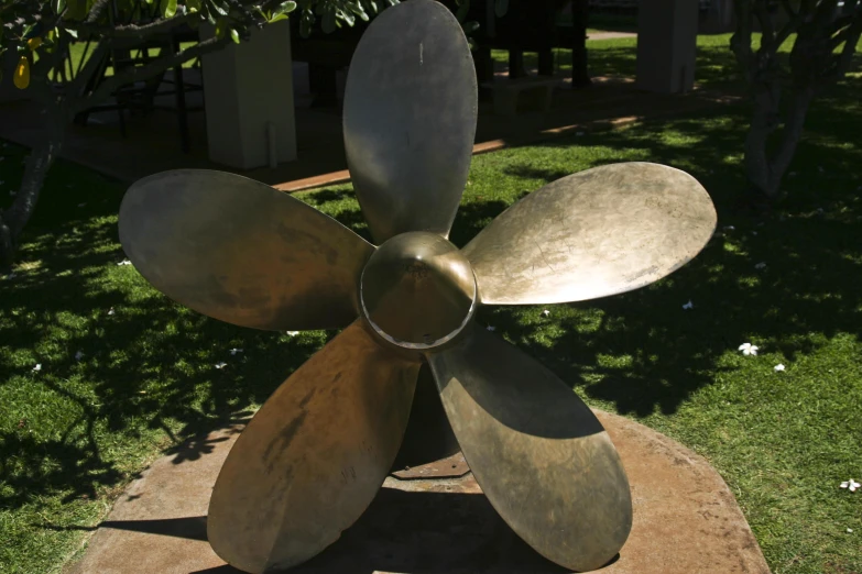 an image of metal propeller on cement slab