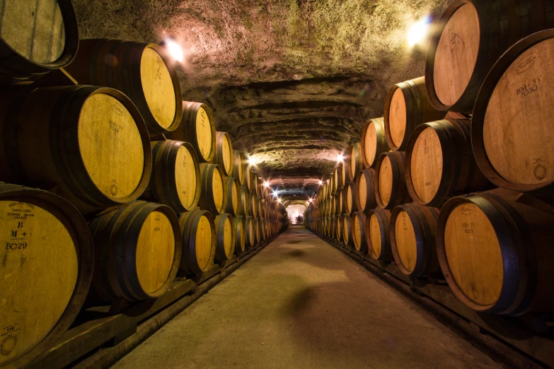 a group of barrels are in a long tunnel