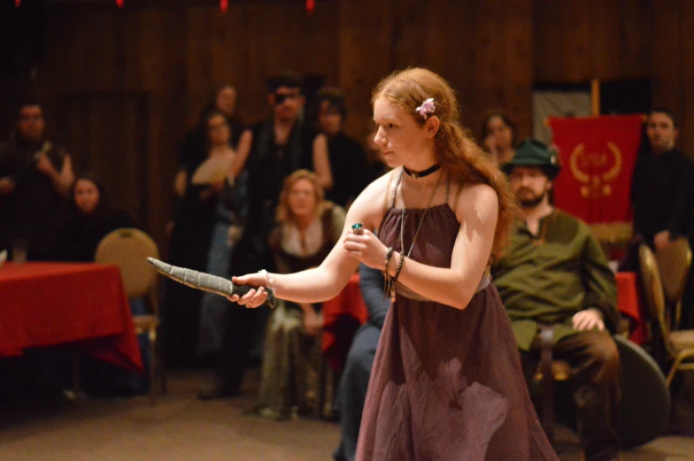 the  is holding a ball bat during an assembly