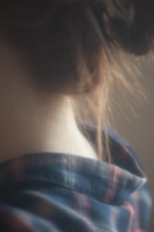 a woman with very long hair wearing a checkered top