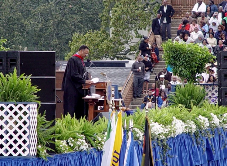 there is a man speaking from a podium at an event