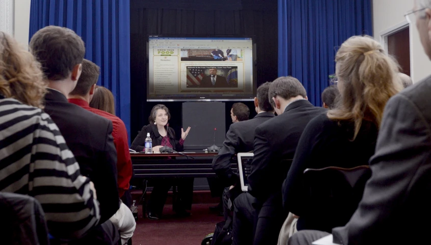 people sitting down in a meeting room for a presentation