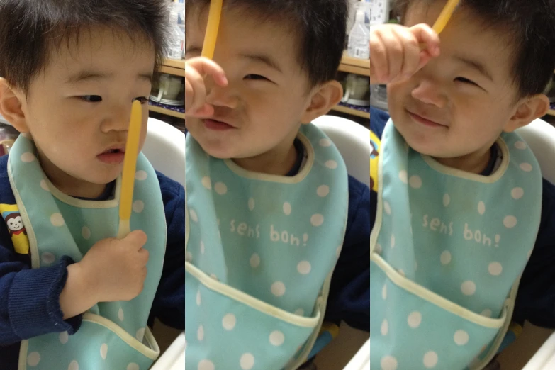 two toddler babies are both wearing bibs with their mouths closed