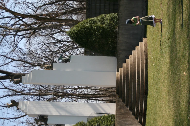 two children are walking toward a monument and a staircase