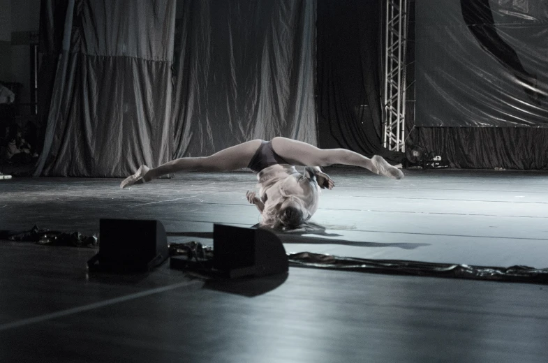 a woman does a handstand while standing on one leg