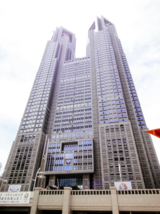 two very tall buildings towering over the city