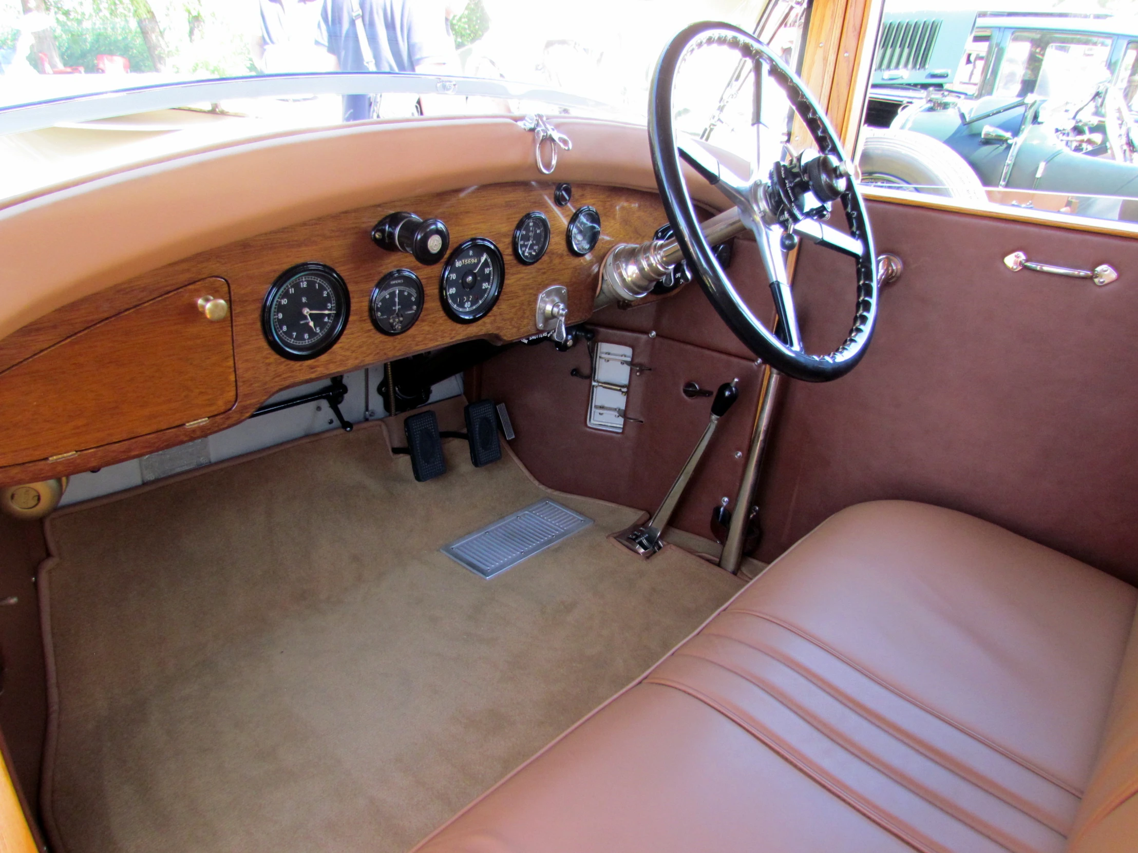 the inside of an old model car is showing the steering and gauges