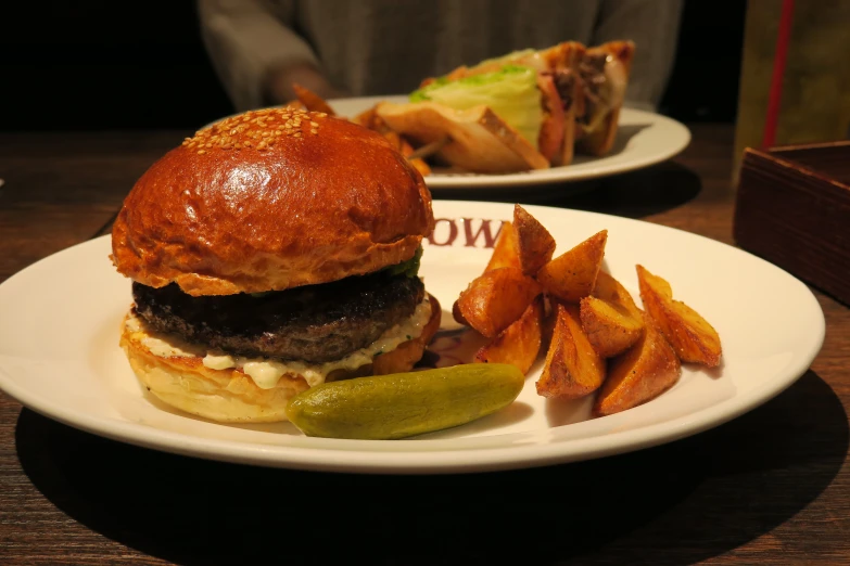 a hamburger and fries are served on a plate