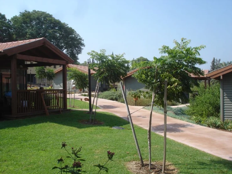 a grassy yard is shown with several buildings