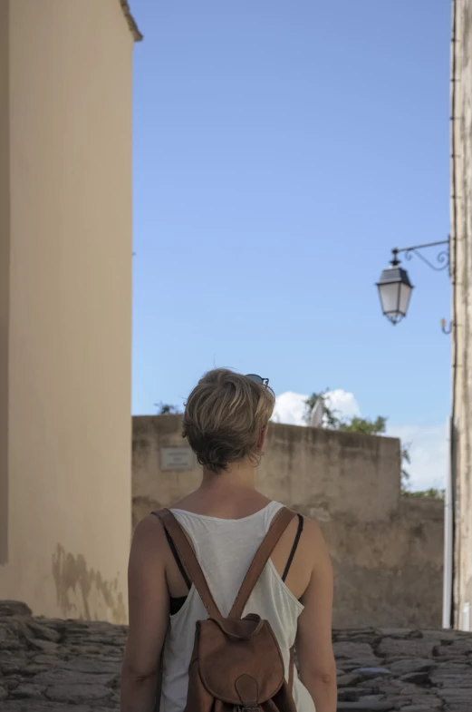 a woman walking down the street in a city