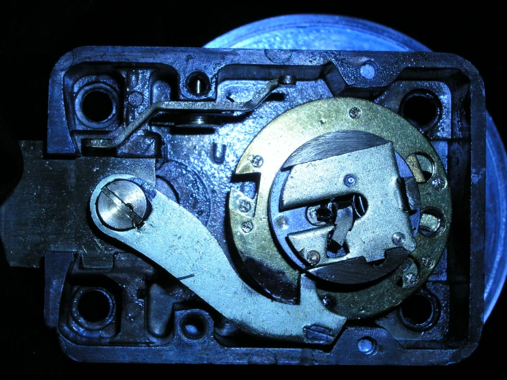 an old clock movement on display on a black background