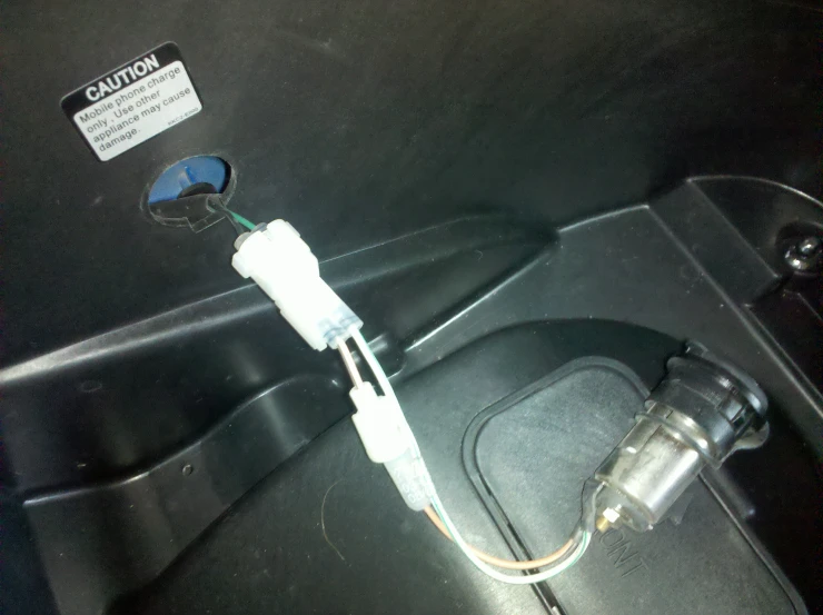 a car door handle and wires attached to the inside