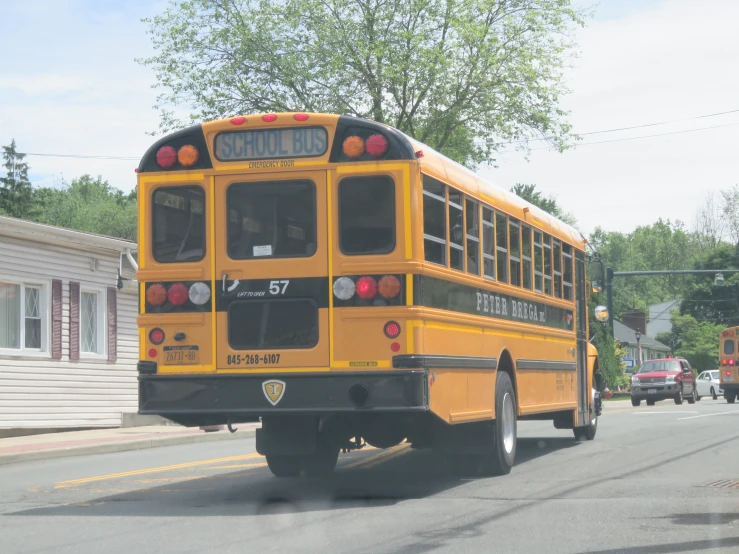 a school bus driving down the road near the building