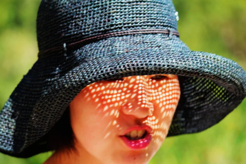 a woman wearing a hat with a design on it