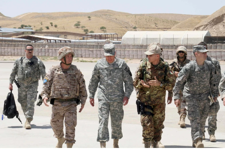 a group of men walking next to each other on a tarmac