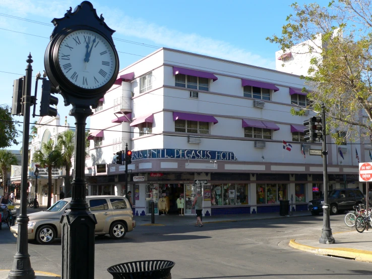 a clock is placed near the intersection of a street