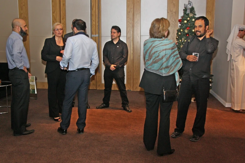 a group of people are standing around talking