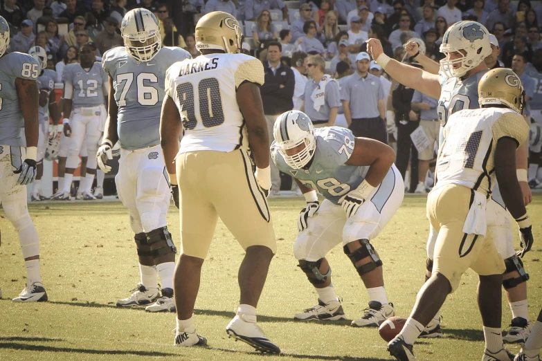 several football players standing around during a game